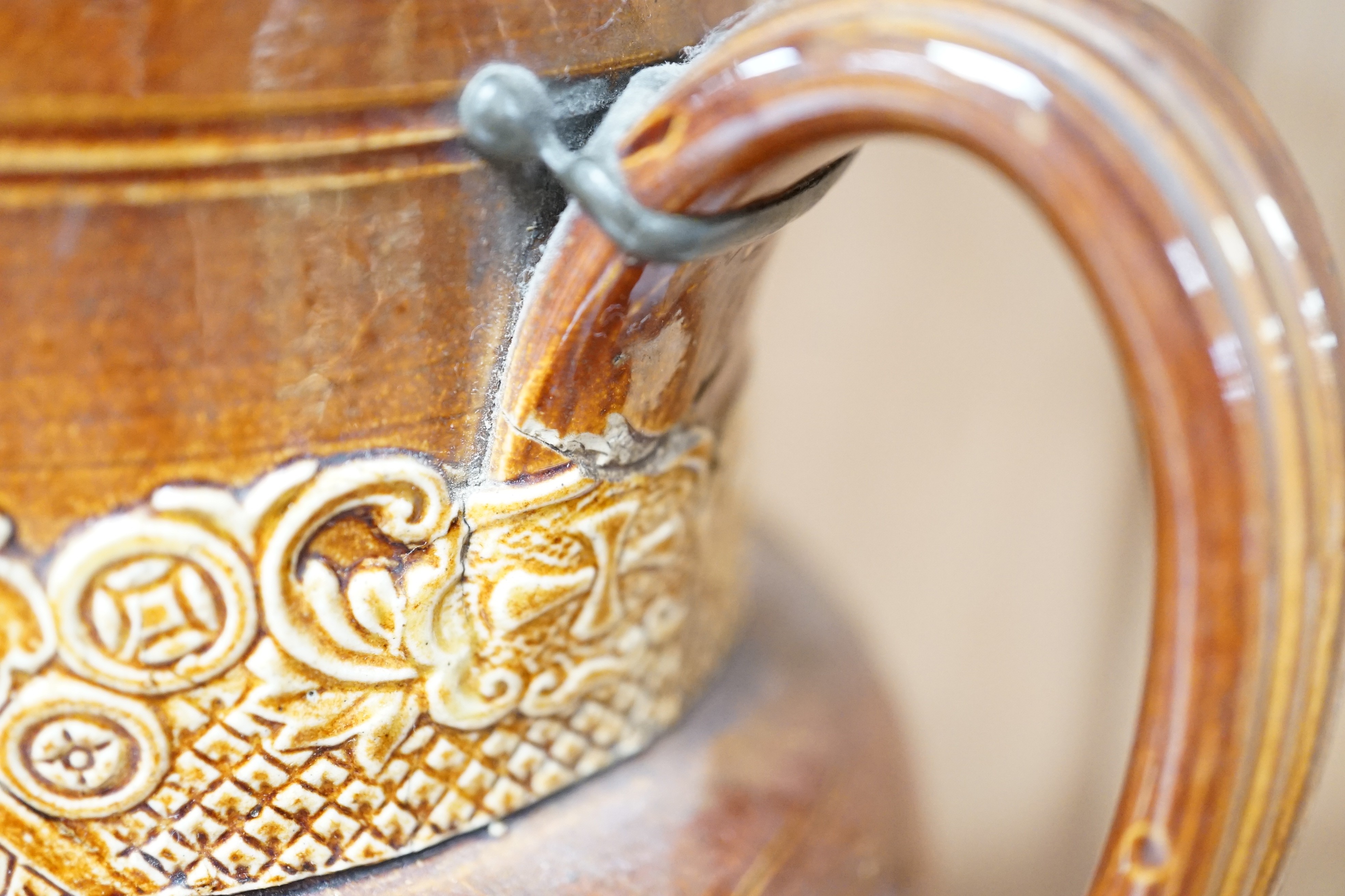 A Victorian solid agate ware pottery jug, a similar bowl and pair of miniature jugs, an unusual Doulton Lambeth stoneware jug and a small relief-moulded teapot, Doulton jug, 19cms high